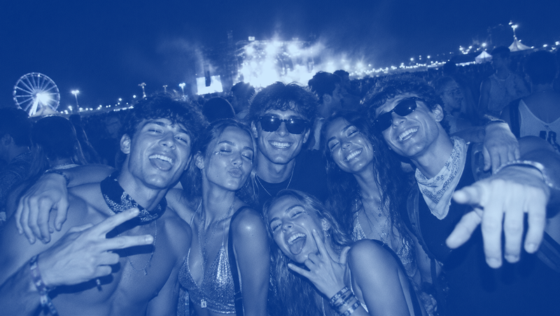 Group of young adults enjoying a music festival crowd at night, representing festival culture, outdoor concerts, summer events, and hydration challenges in large gatherings