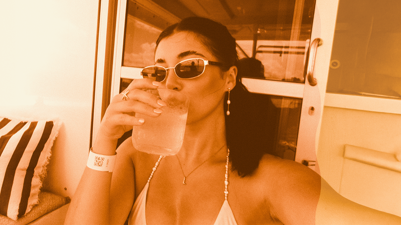 A woman drinking a cold glass of water.